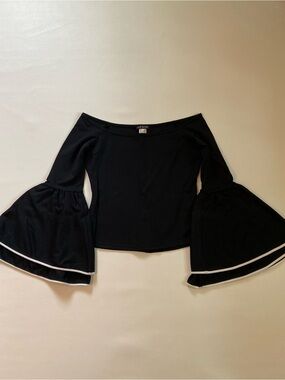 Off the shoulder black knit top with 3/4 length ruffled sleeves